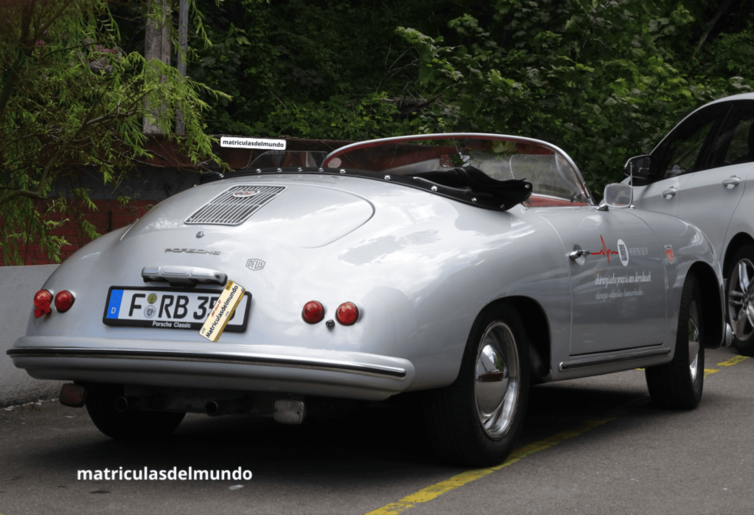 Porsche 356 deportivo y descapotable gris con matrícula alemana de Frankfurt aparcado en una calle de España